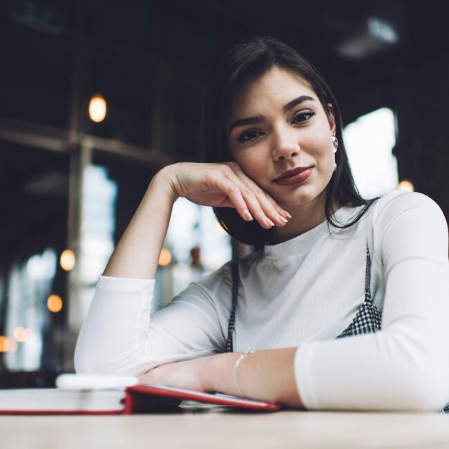 Content woman at table in cafe