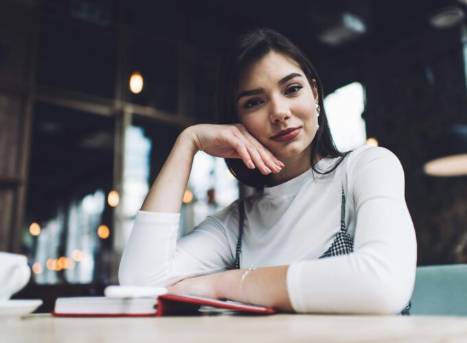 Content woman at table in cafe